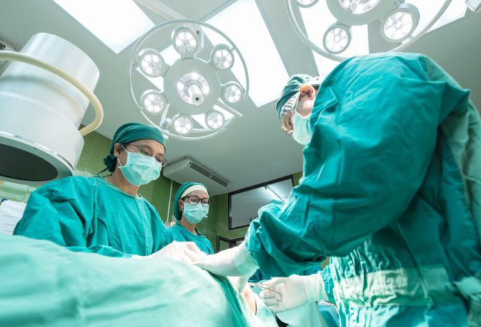 Team of surgical technicians in an OR.