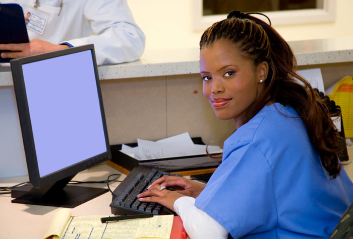 Medical Assistant in front of the computer