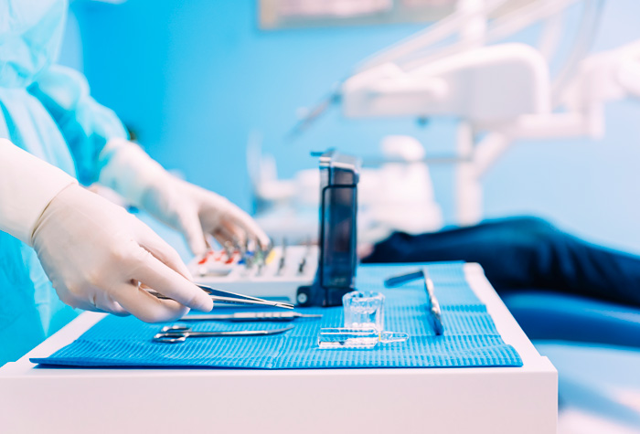 Dental School in Milwaukee with a tray of dental tools and a dental assistant student.
